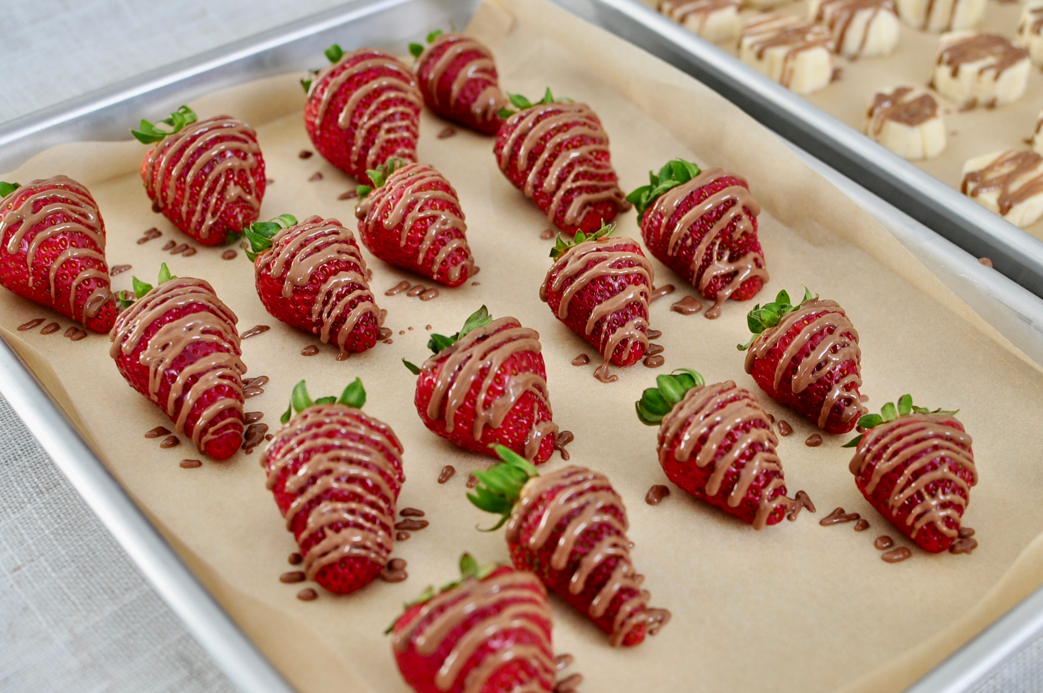 Drizzle chocolate on strawberries