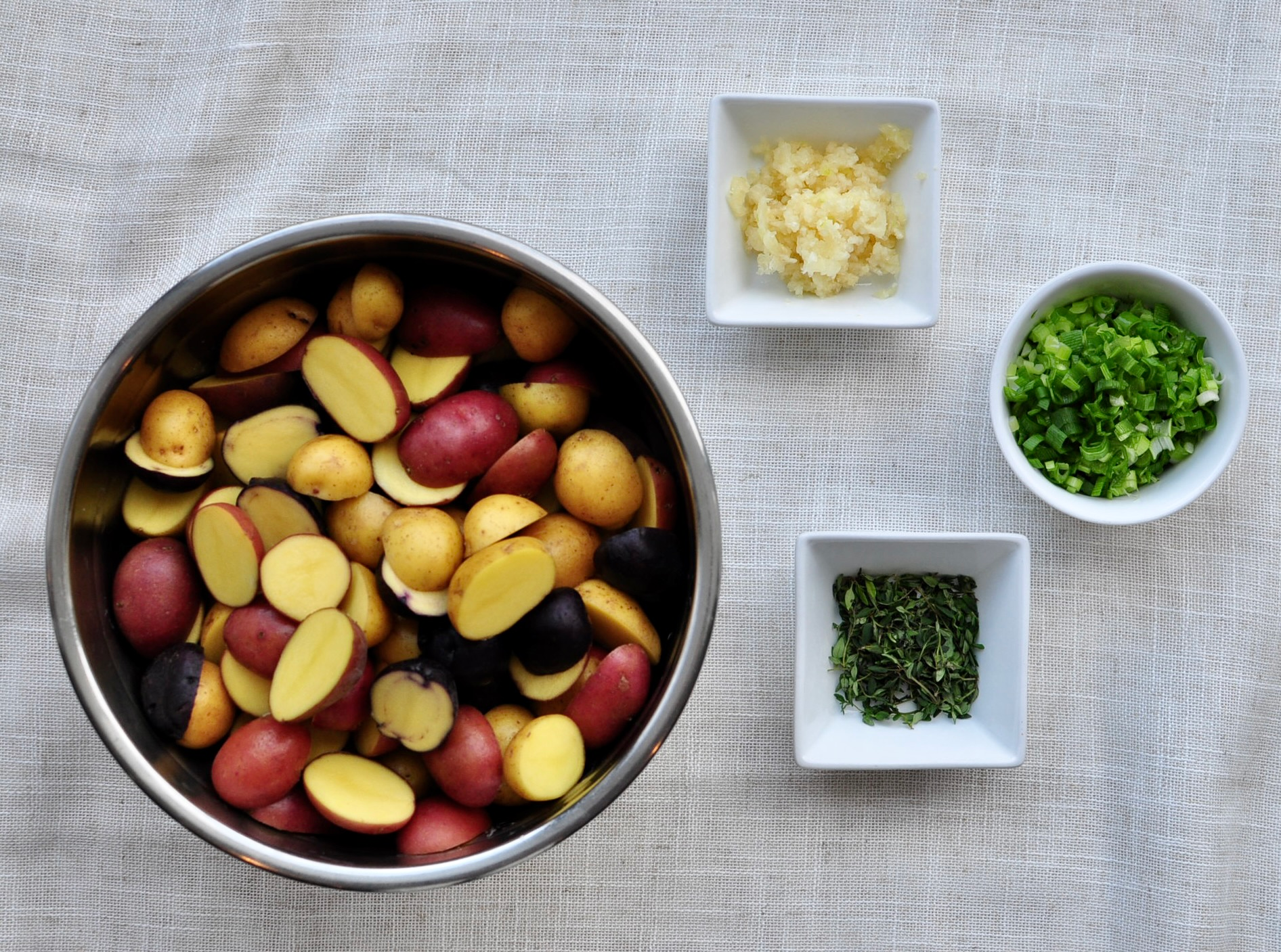 Cut little potatoes, garlic, thyme, scallions