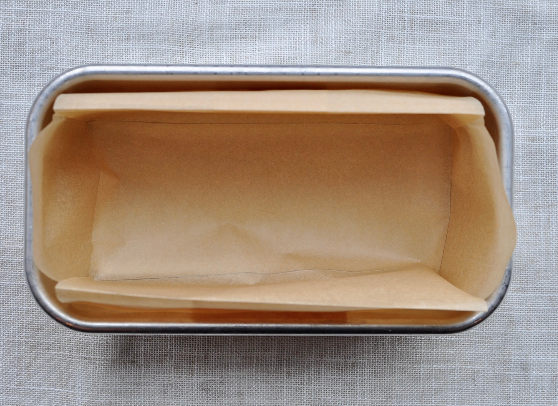 Folded piece of parchment paper for loaf pan
