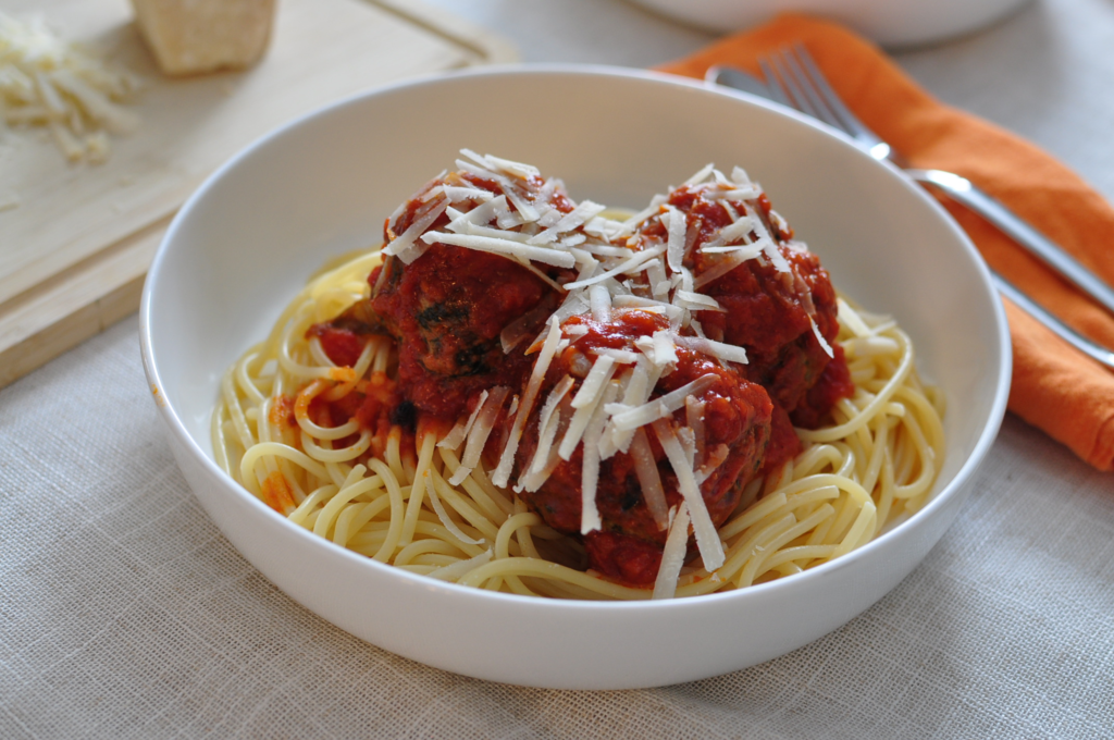 Spaghetti and meatballs with grated parmesan cheese