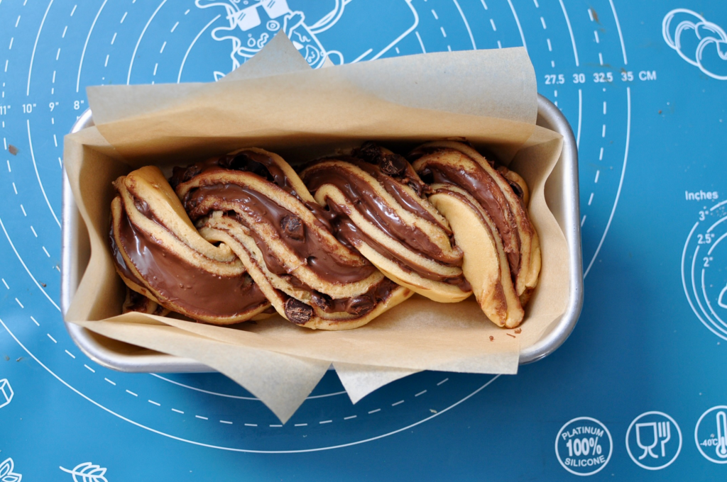twisted babka dough in loaf pan
