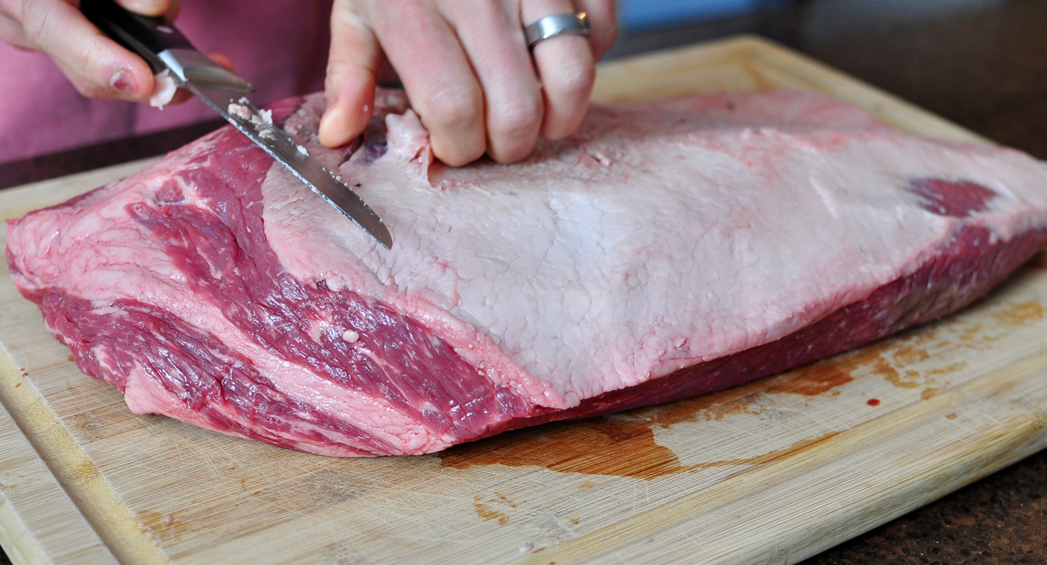 Remove the hard fat and leave 1/4 inch of fat on the fat side of the brisket.