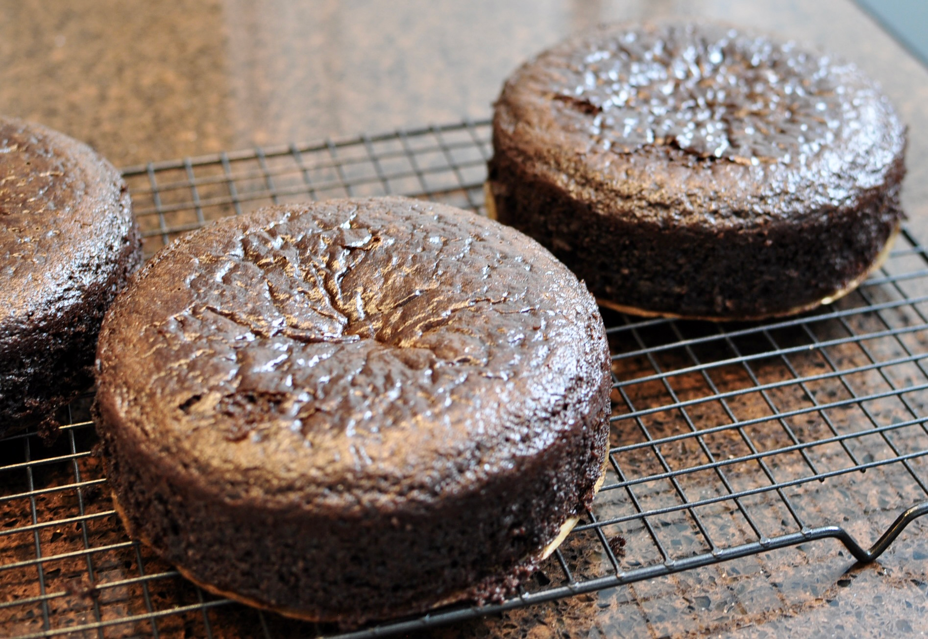 Chocolate layer cake cooling on wire rack