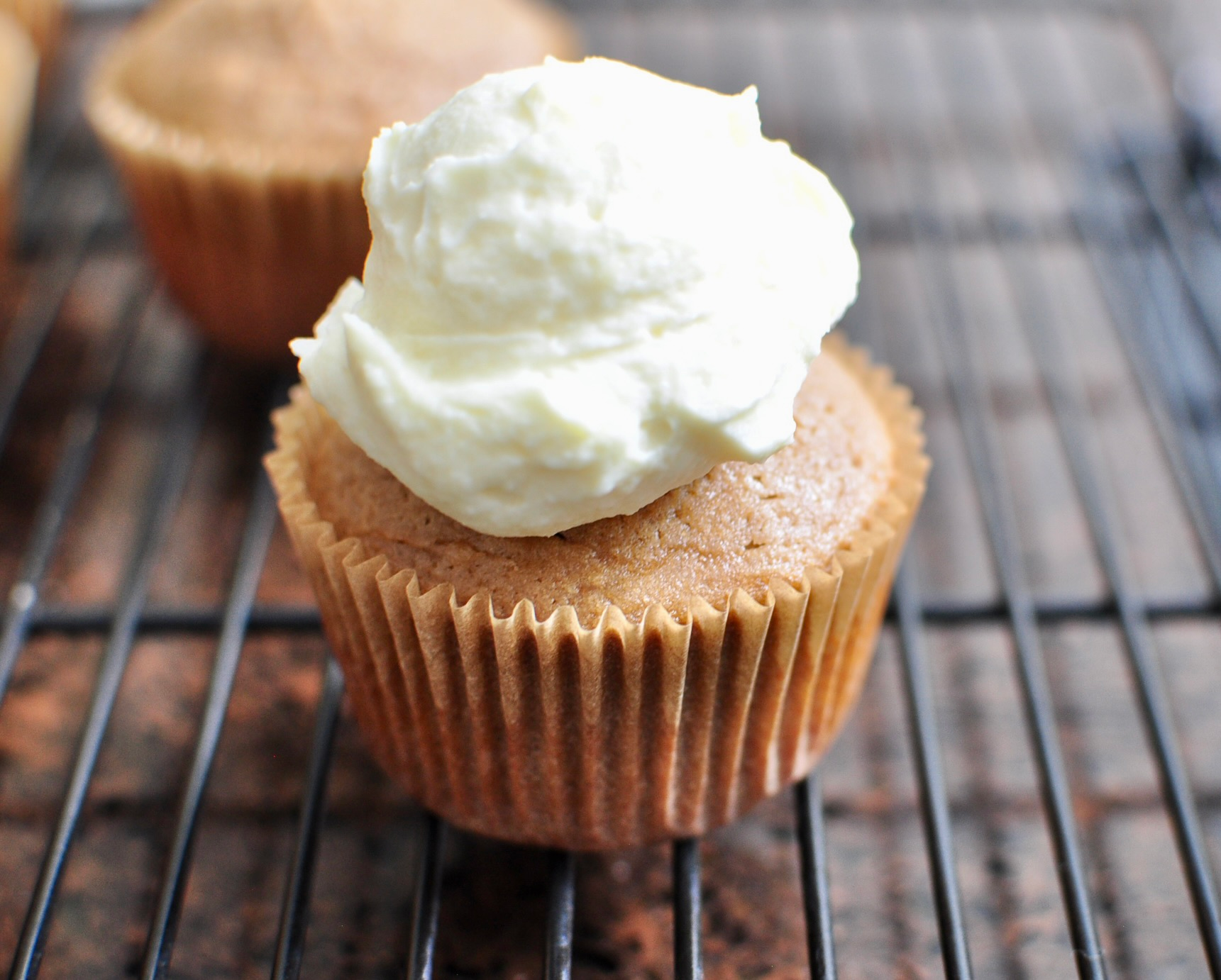 Dollop of whipped vanilla ganache on milk tea cupcake