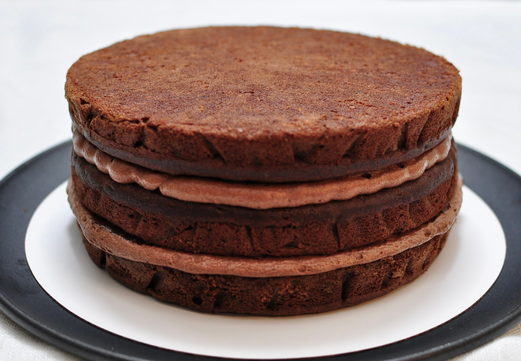 Frost three layer chocolate ganache cake with ganache and whipped ganache
