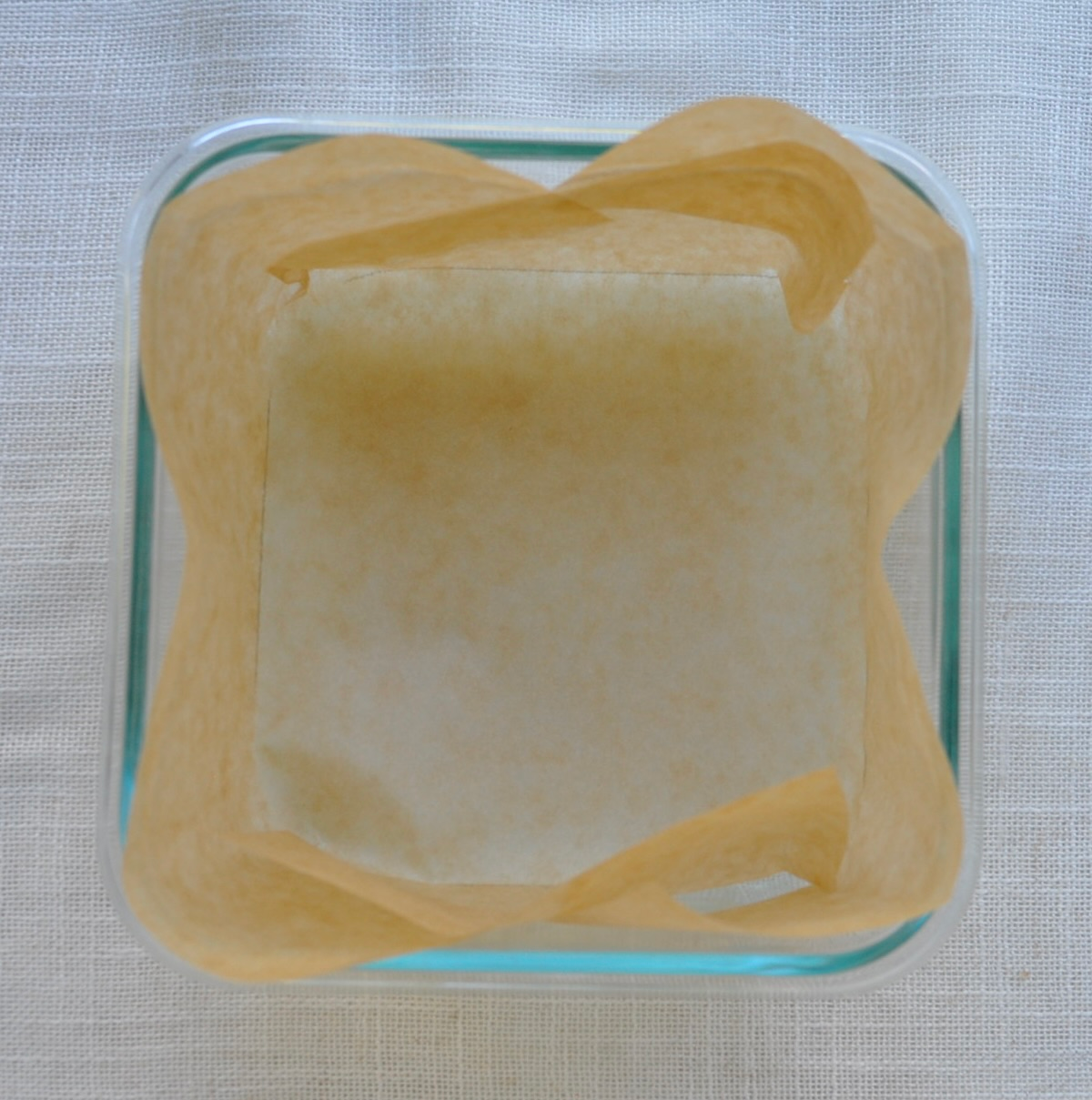 Parchment lined container for steaming Strawberry Mochi Squares